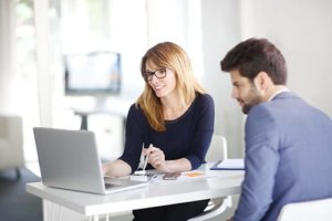 A woman talks to a man about addiction treatment and behavioral health consulting services